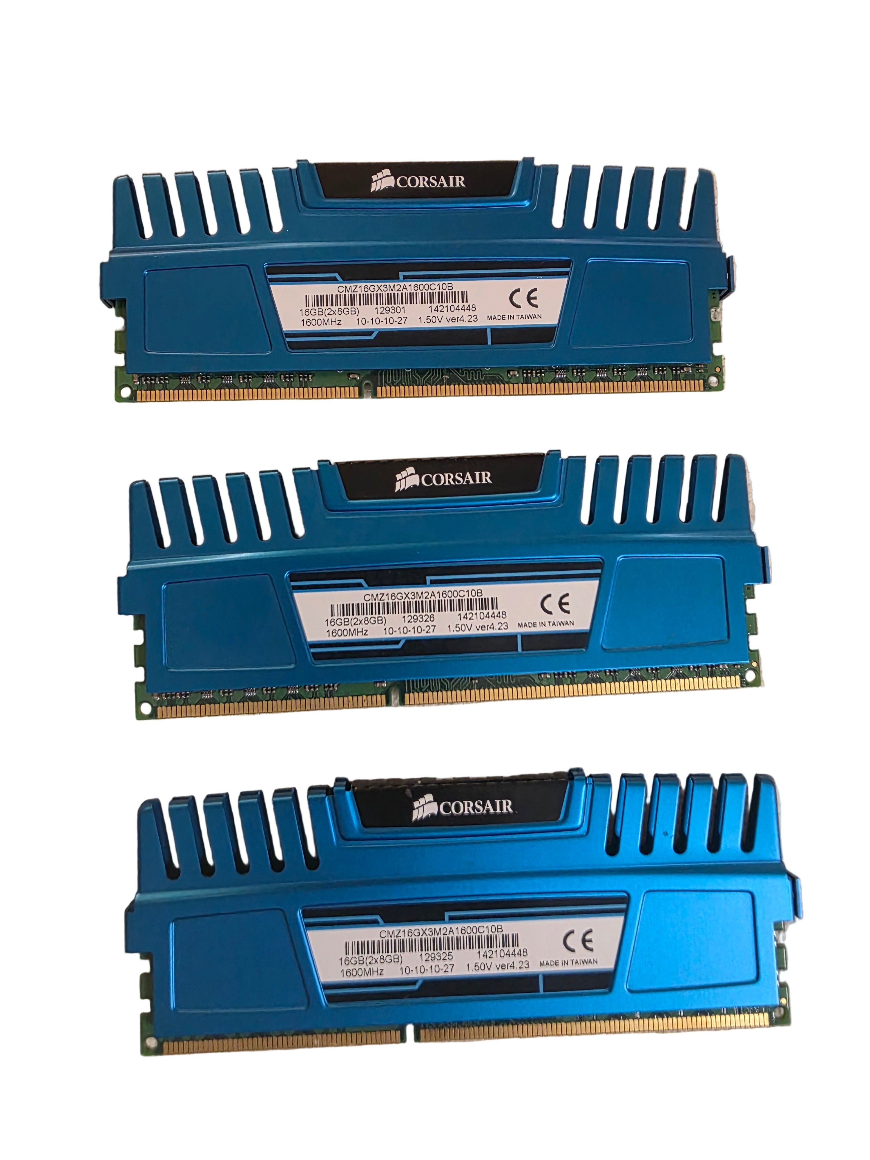 Three blue Corsair RAM sticks on a beige surfaceCorsair Vengeance 8GB DDR3 Desktop RAM Memory Module - Blue-Used