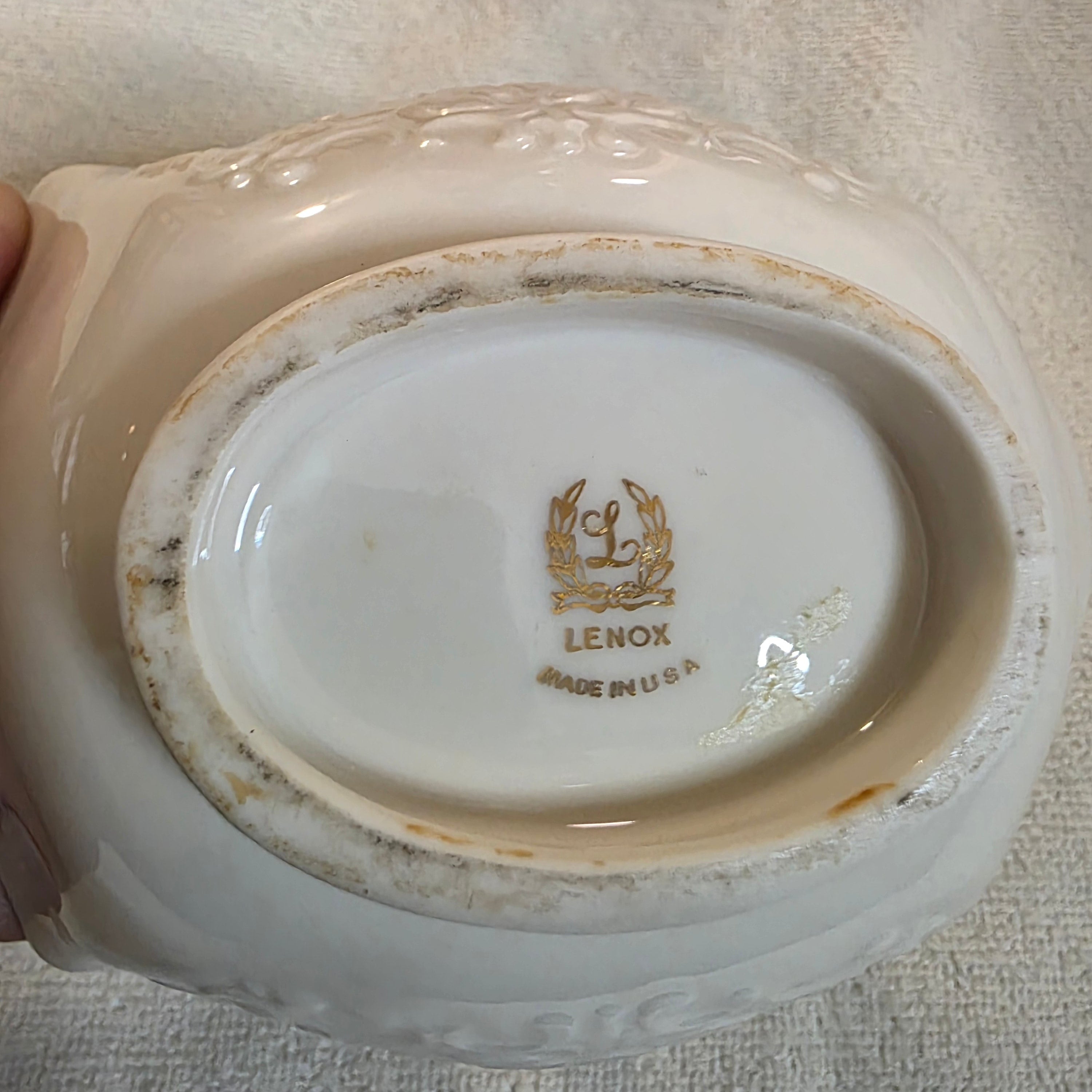 Back of a Lenox china dish with visible branding on a textured surface, Toaashop.com