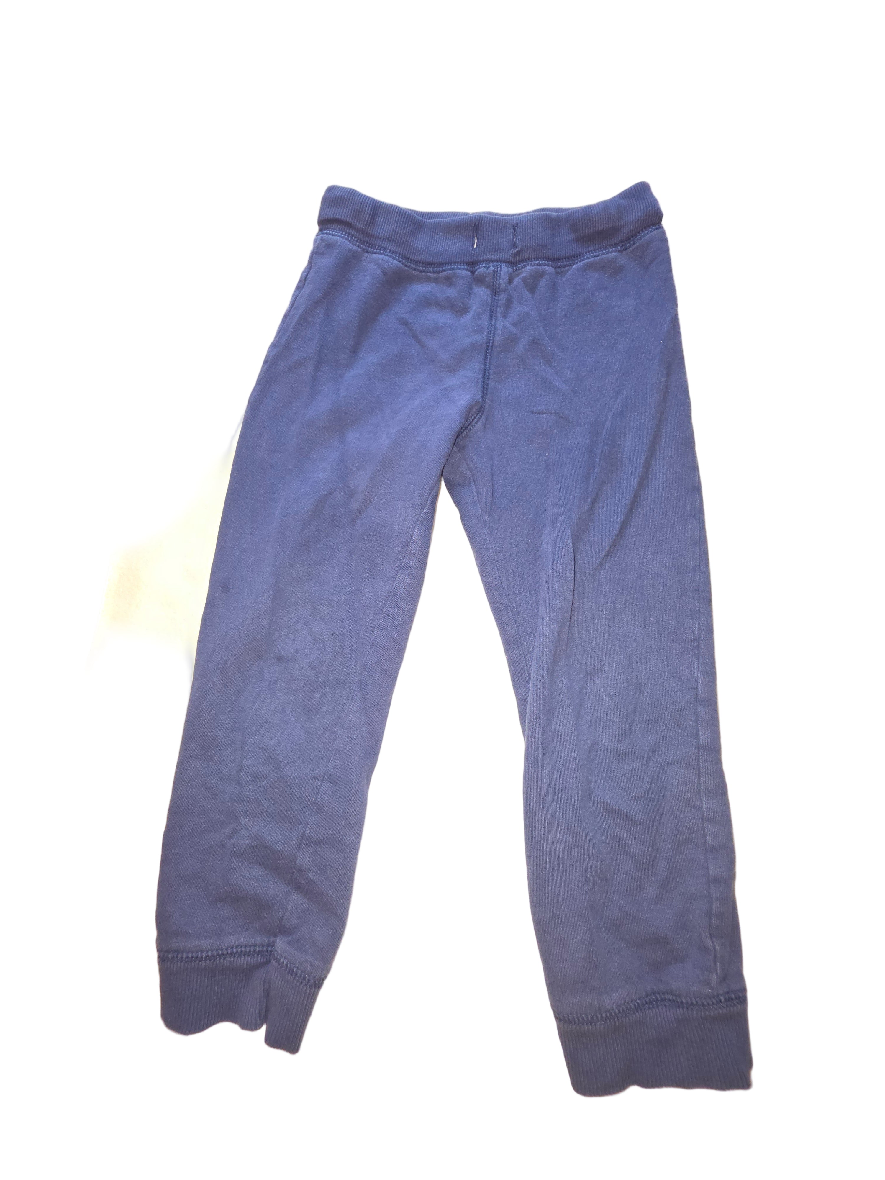 Blue jeans on a white surface with a blurred background