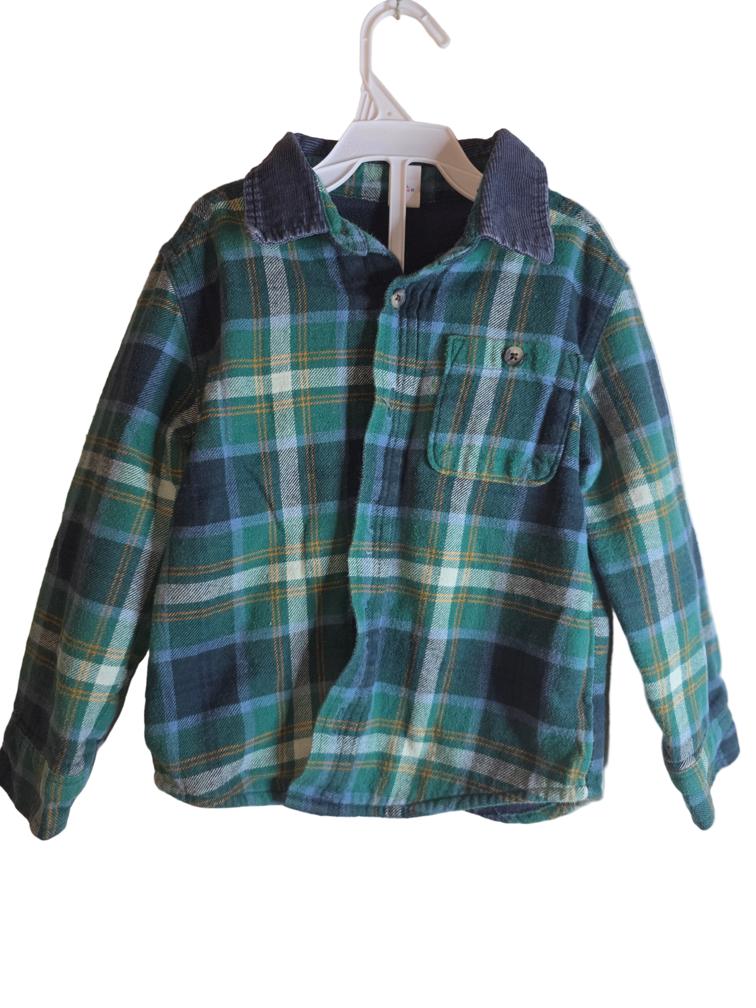 Green and blue plaid shirt on a beige background