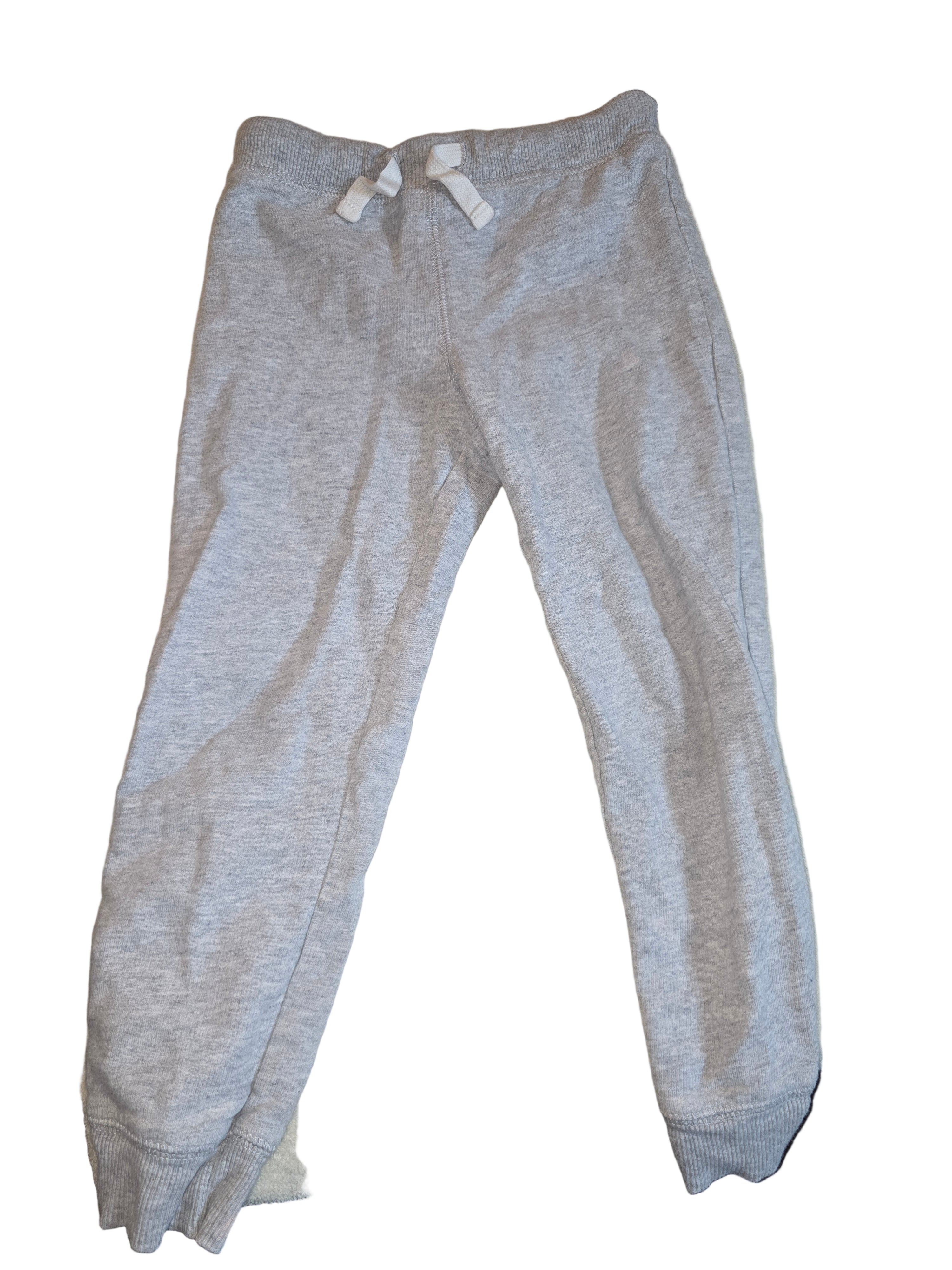 Gray sweatshirt on a beige surface with a blurred background