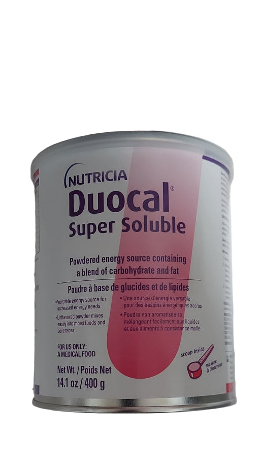 Can of Nutricia Duocal Super Soluble on a white surface with a person wearing purple shoes in the foreground.