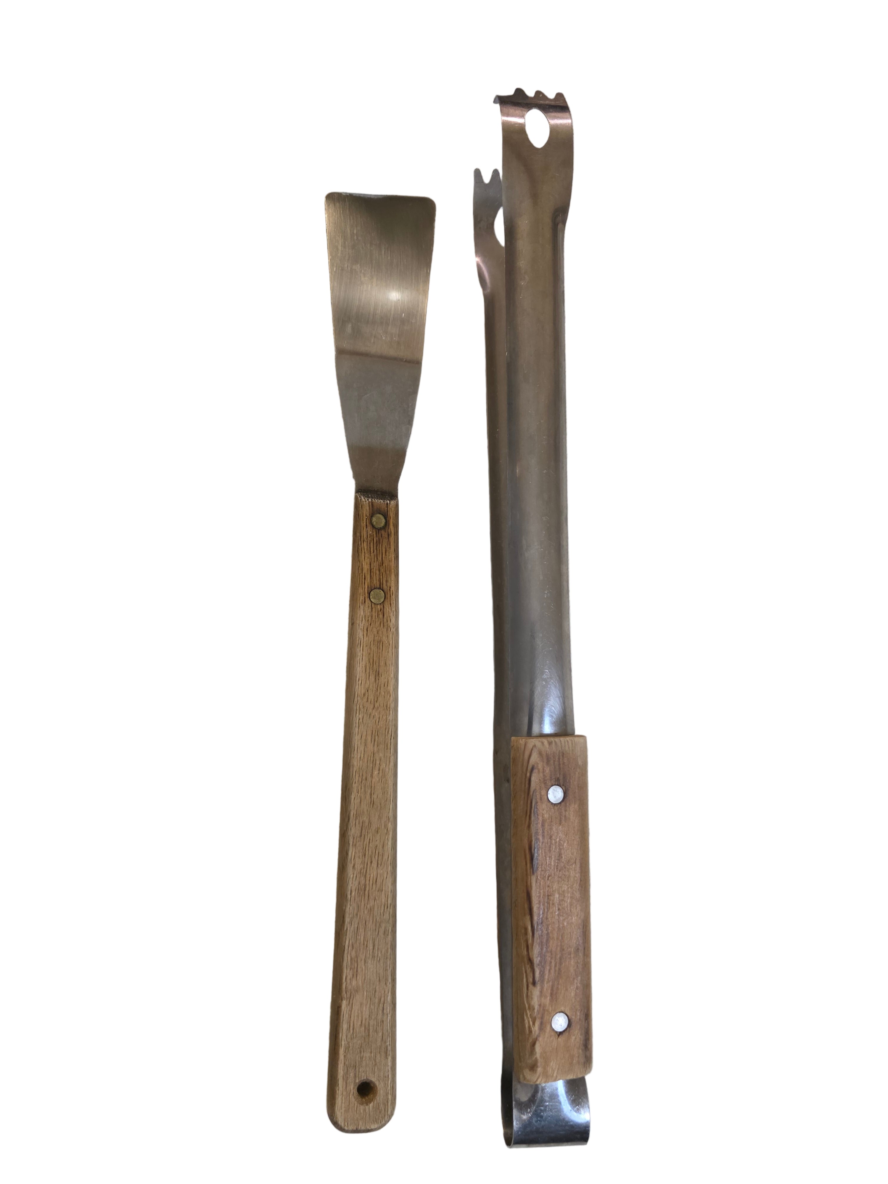 Two metal tools with wooden handles on a beige fabric background